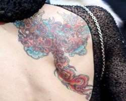 She has two tattoos one is a beautiful tattoo on her back and other is a cat tattoo on the outer part of her left leg.